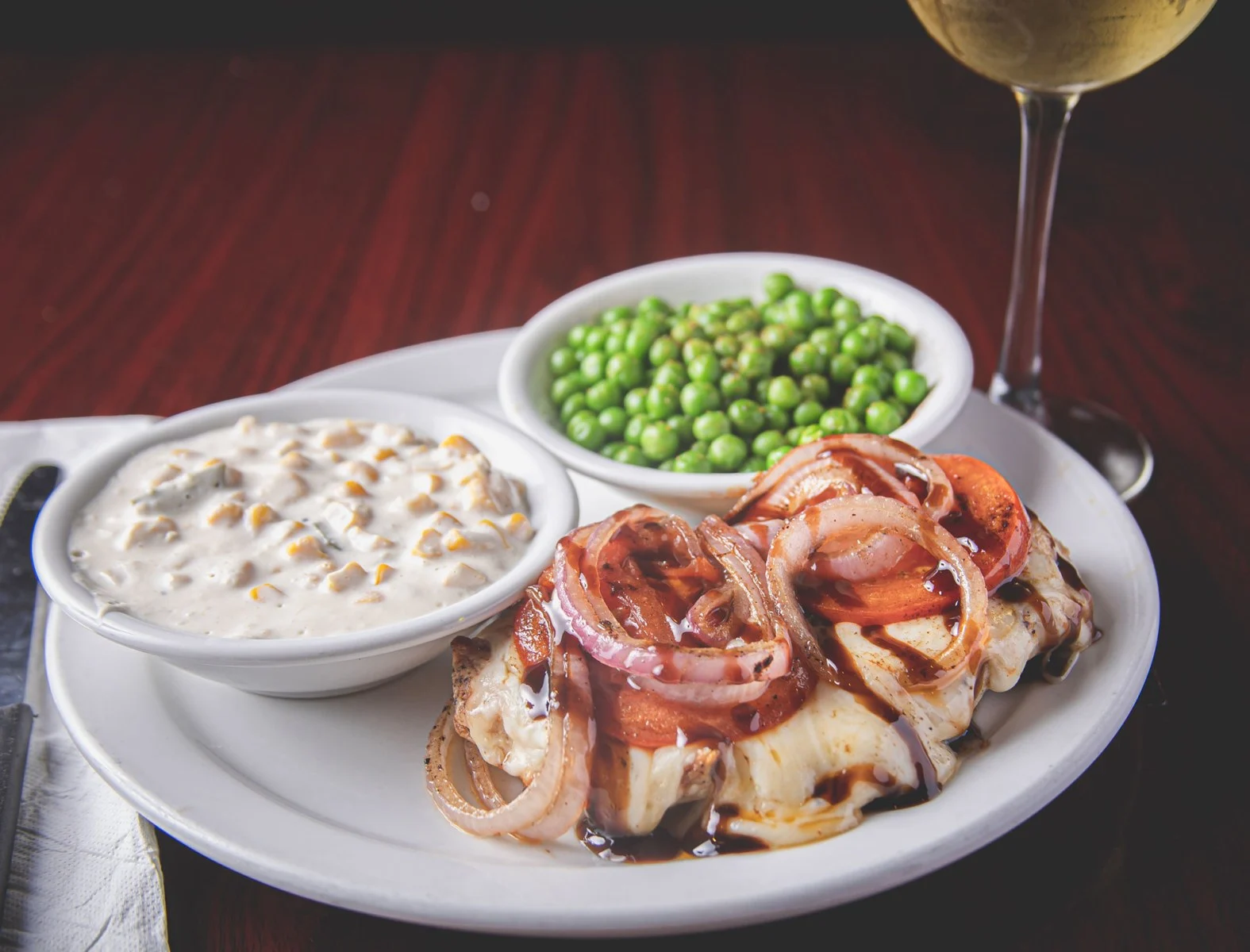 Official Wurst Haus plated entree with onions and sides; exact dish name unconfirmed