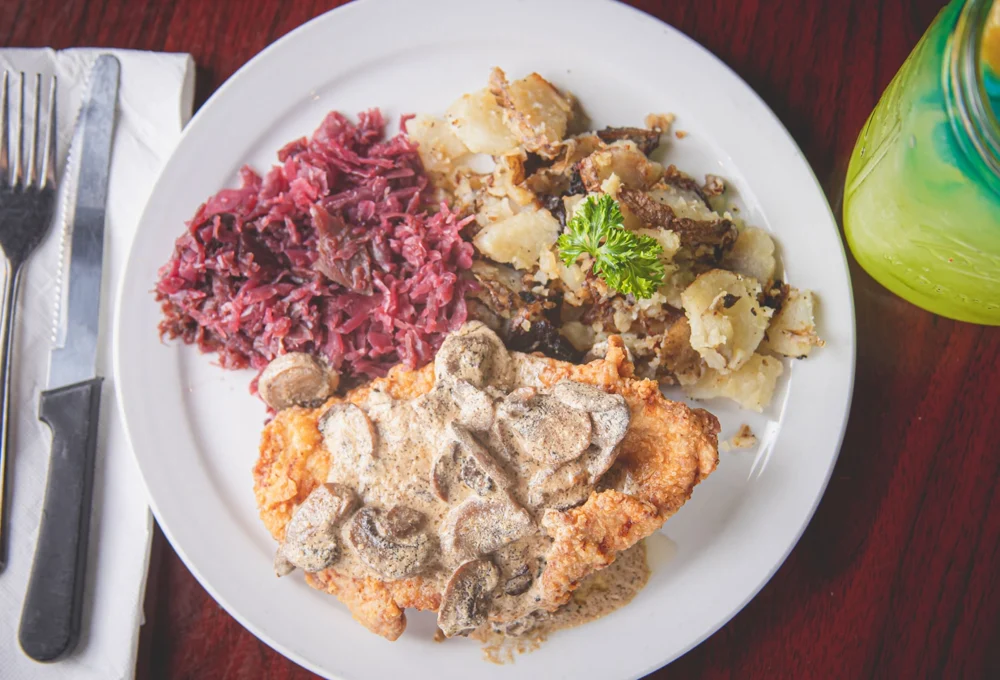 Schnitzel with mushroom sauce, red cabbage and potatoes